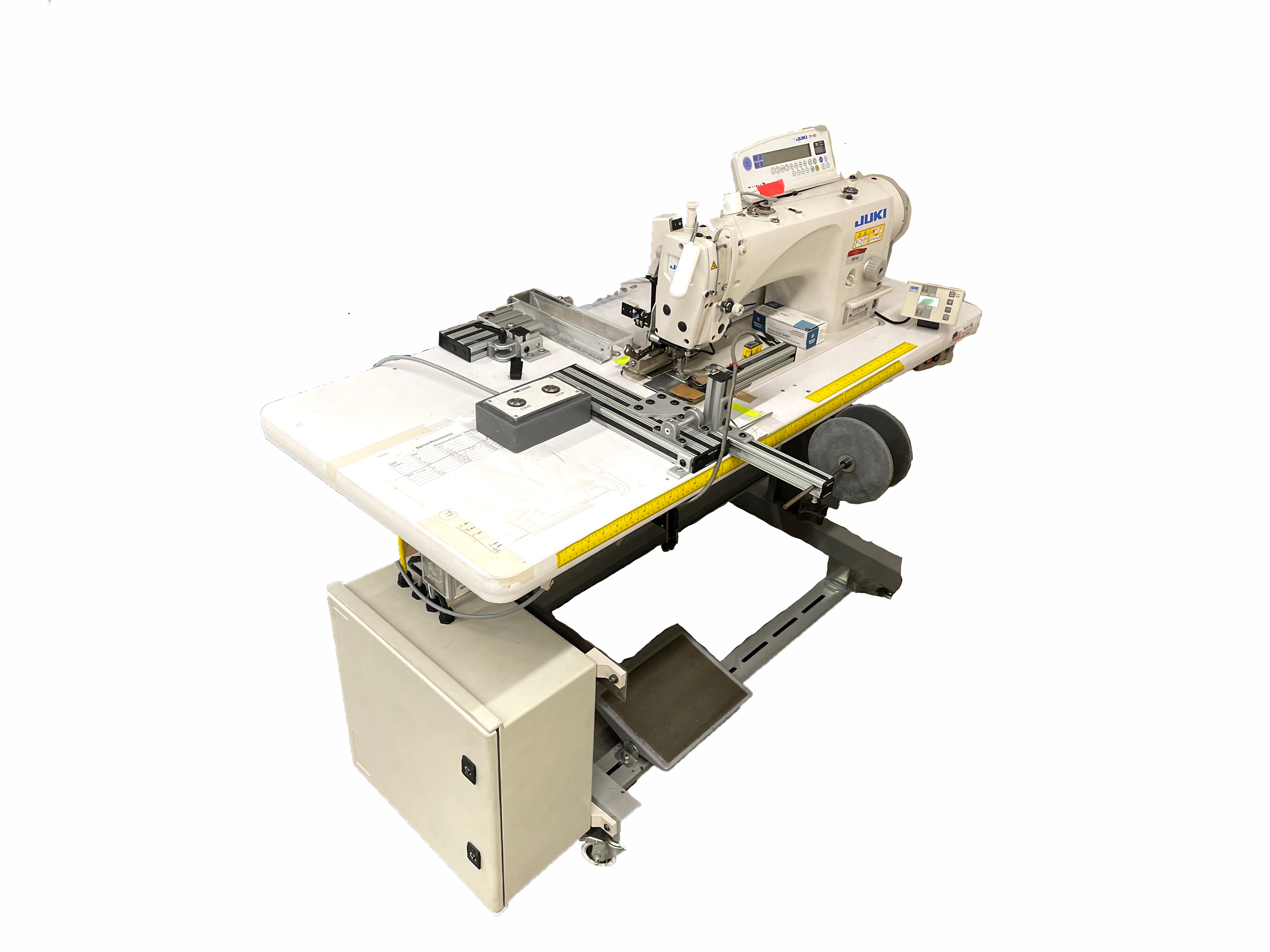 Fully automated sewing machine used to fold, sew, and cut to length a strip of rip stop fabric. 